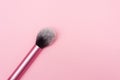 Close up of a make up brush. makeup brush for powder foundation isolated on pink background Royalty Free Stock Photo