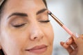 Close-up of a make-up artist applying eye shadow to her client. Royalty Free Stock Photo