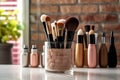 Close-up of makeup brushes in a glass jar on table in stylist room on light background, concept of women\'s cosmetics