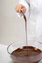 Close up making organic hand-crafted chocolate, pouring dark melted chocolate