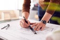 Close Up Of Male Architect In Office Drawing On Plan Or Blueprint With Ruler