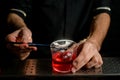 Close-up bartender decorating cocktail glass with coconut slices Royalty Free Stock Photo