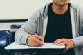 Close up , male with beard , holding pencil exams writing in classroom for education test Royalty Free Stock Photo