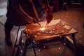 Close Up Of Male Blacksmith Arc Welding Metalwork In Forge