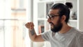 Close up of male blogger pointing down, asking followers to subcribe, recording video blog or vlog at home studio