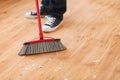 Close up of male brooming wooden floor Royalty Free Stock Photo