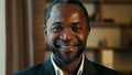 Close-up male business portrait smiling contented adult african american man standing indoors looking at camera happy Royalty Free Stock Photo