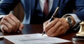 A close-up of a male businessman signing a contract with a pen Royalty Free Stock Photo