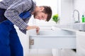 Male Carpenter Installing Drawer