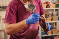 Carpenter paints a wooden