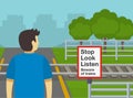 Close-up of male character looking both ways to cross the railways. Stop, look, listen and beware of trains. Royalty Free Stock Photo