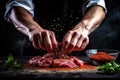 Close up of male chef\'s hands preparing fresh meat on black background