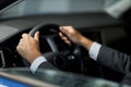 Close up of male client testing new car at showroom