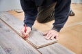 Male worker hands drawing mark on laminate plank. Royalty Free Stock Photo