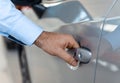 Close up of a male customer hand opening a car door at the dealership Royalty Free Stock Photo