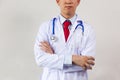 Close-up of male doctor with arms folded having stethoscope on his neck isolated on white background. Royalty Free Stock Photo