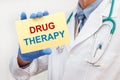 Close-up of a male doctor holding a sign with the text Drug Therapy