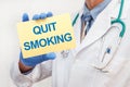 Close-up of a male doctor holding a sign with the text QUIT SMOKING Royalty Free Stock Photo