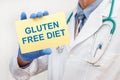 Close-up of a male doctor holding a sign with the text GLUTEN FREE DIET