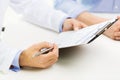 Close up of male doctor and patient with clipboard Royalty Free Stock Photo