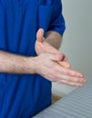 Close-up of male doctor sanitizes hands before massage