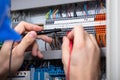 Male Electrician Examining Fuse Box With Multimeter Royalty Free Stock Photo