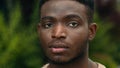 Close up male face serious millennial young African American ethnic guy handsome portrait sad calm strong man in city Royalty Free Stock Photo