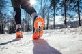 Close up of male feet running along winter road Royalty Free Stock Photo