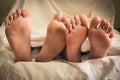 Close up of male and female feet on a bed and couple having sex Royalty Free Stock Photo