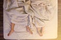 Close up of male and female feet sleeping on a bed in the bedroom