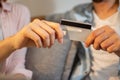 Close up of male and female hands holding bank card together. Man and woman holding credit card in hands together Royalty Free Stock Photo