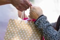 Close-up of male and female hands holding shopping bags Royalty Free Stock Photo