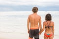 Close up male and female hands holding together on blurred sea a Royalty Free Stock Photo