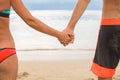 Close up male and female hands holding together on blurred sea a Royalty Free Stock Photo