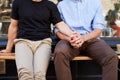 Close Up Of Male Gay Couple Sitting Outside Coffee Shop Holding Hands Royalty Free Stock Photo