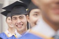 Close Up of Male Graduate Student Standing in a Row of Graduates Royalty Free Stock Photo