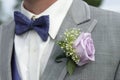 Close-up of male groomsman attire with pink rose corsage
