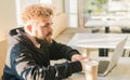 Close-up male guy portrait resting in coffee shop chatting in social networks skilled freelancer enjoying remote job Royalty Free Stock Photo
