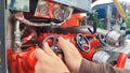 Close up of male hand on control valve in fire engine Royalty Free Stock Photo