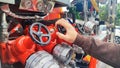Close up of male hand on control valve in fire engine Royalty Free Stock Photo