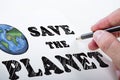 Close up of male hand drawing save the planet sketch on background. Earth day concept Royalty Free Stock Photo