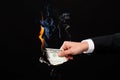 Close up of male hand holding burning dollar money Royalty Free Stock Photo