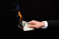 Close up of male hand holding burning dollar money Royalty Free Stock Photo