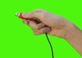 Close up male hand holding red usb cable for PC and mobile devices isolated on green background, concept of communication Royalty Free Stock Photo