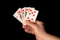 Close up male hand holding Royal Flush cards while playing poker Royalty Free Stock Photo