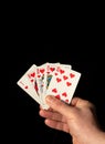 Close up male hand holding Royal Flush cards while playing poker Royalty Free Stock Photo