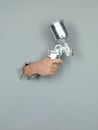 Male hand holding a spray gun