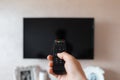 Close-up of male hand holding TV remote controller. Royalty Free Stock Photo