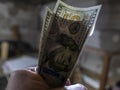 Close up of male hand holds two banknotes of hundred dollars. new hundred-dollar bills.Money USA dollar banknotes