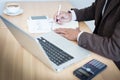 Close-up of male hand making notes in office